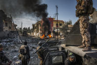 <p>The battle for Mosul: Iraqi Special Forces soldiers survey the aftermath of an attack by an ISIS suicide car bomber, who managed to reach their lines in the Andalus neighborhood, one of the last areas to be liberated in eastern Mosul, Jan. 16, 2017.<br><br>On July 10, 2017, after months of fighting, the Iraqi government declared the city of Mosul fully liberated from ISIS, although fierce fighting continued in pockets of the city. Mosul had fallen to ISIS three years earlier, and the battle to retake it had begun in Oct. 2016.<br>In effect, the reconquering of Mosul comprised two parts: the battle for the eastern half of the city, and that for the west, across the Tigris River. East Mosul was recaptured by the end of Jan. 2017, but the offensive on west Mosul, particularly the densely built-up Old City, proved more difficult. Large areas of the city were left in ruins, and huge numbers of civilians were caught in the crossfire as battle raged.<br>A United Nations report gives an absolute minimum of 4,194 civilian casualties during the conflict, with other sources putting the figure much higher. The Office of the UN High Commissioner for Human Rights pointed to extensive use of civilians as human shields, with ISIS fighters attempting to use the presence of civilian hostages to make certain areas immune from military operations.<br>After months of being trapped in the last remaining ISIS-held areas of the city, the people in west Mosul were severely short of food and water. Those who chose to remain in the city rather than go to one of the many camps for displaced people, initially relied on aid in order to survive. (Photo: Ivor Prickett for The New York Times) </p>