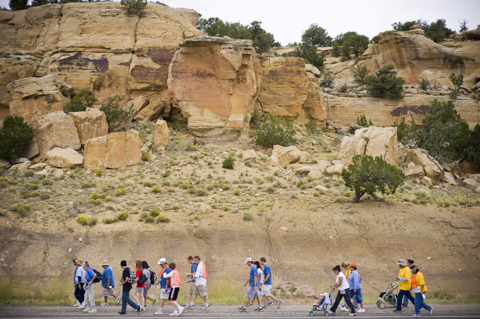 FILE - In this July 16, 2009, file photo, a group of walkers moves south along highway 566 during a commemorative walk in Church Rock, N.M., to mark the 30th anniversary of a uranium tailings spill. A group representing Navajo communities is presenting its case to an international human rights body, saying U.S. regulators violated the rights of tribal members when they cleared the way for uranium mining in western New Mexico. (Cable Hoover/Gallup Independent via AP, File)