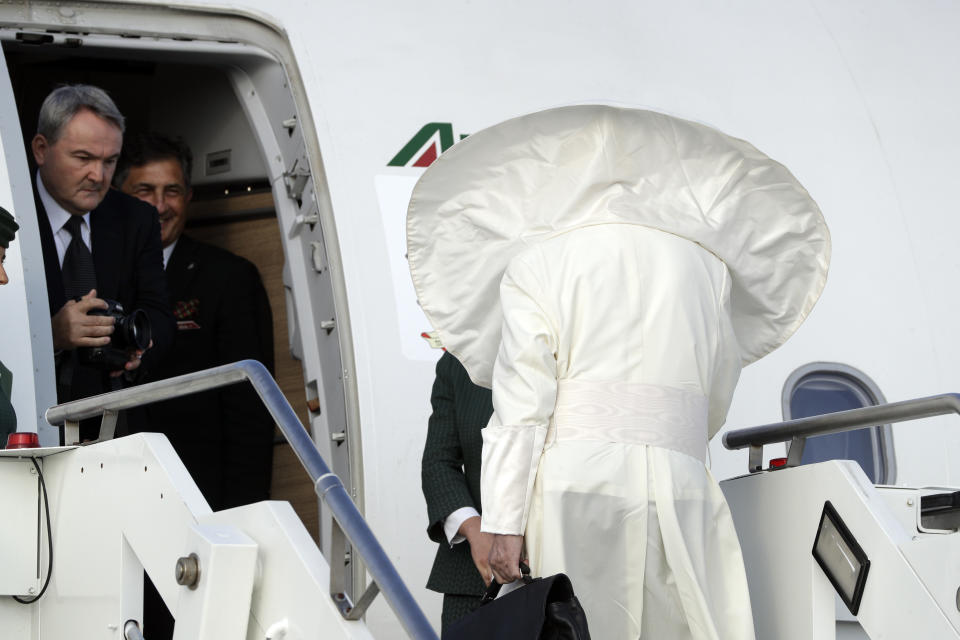 A gust of wind blows Pope Francis' cape as he boards an airplane at Rome's Fiumicino international airport, Saturday, Aug. 25, 2018. The pontiff is traveling to Ireland for a two-day visit on the occasion of the 2018 World Meeting of Families. (AP Photo/Andrew Medichini)