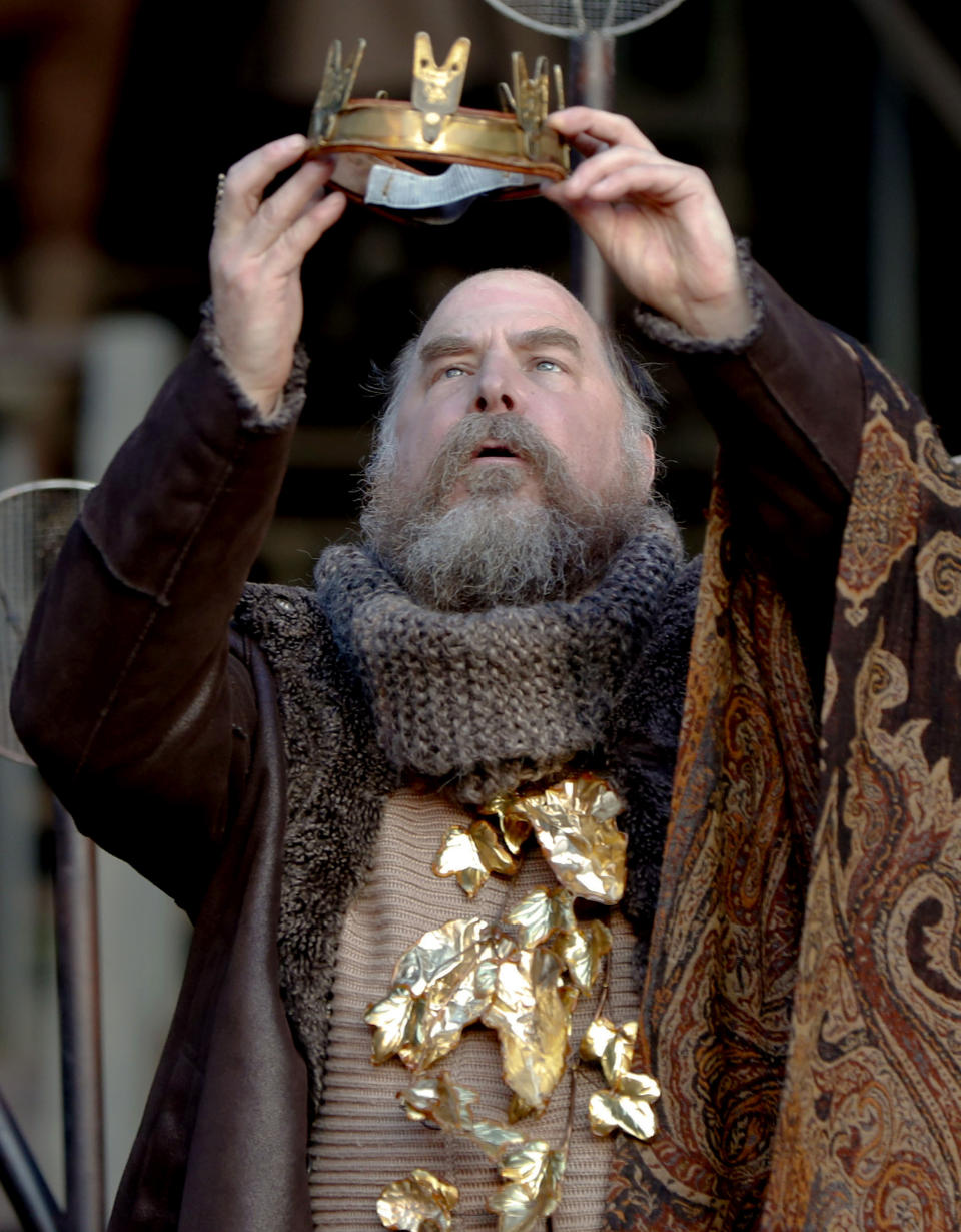 In this photo made on Saturday, May 18, 2019, actor Jeffrey Carpenter, portraying the character King Lear, performs in the opening scene of the Quantum Theatre production of Shakespeare's tragedy at the site of the old Carrie steel producing blast furnace in Swissvale, Pa.Karla Boos, the artistic director said using this backdrop gives a sense of the enormity of the steel industry and the enormity of its collapse and those are wonderful metaphors for "King Lear." It tells of grief and madness, family values gone wrong and a powerful king brought low. The Carrie Furnaces are the last remaining structures of the Homestead Steel Works. (AP Photo/Keith Srakocic)