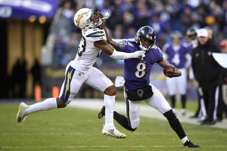<p>Baltimore Ravens quarterback Lamar Jackson, right, rushes against Los Angeles Chargers free safety Derwin James in the second half of an NFL wild card playoff football game, Sunday, Jan. 6, 2019, in Baltimore. (AP Photo/Nick Wass) </p>