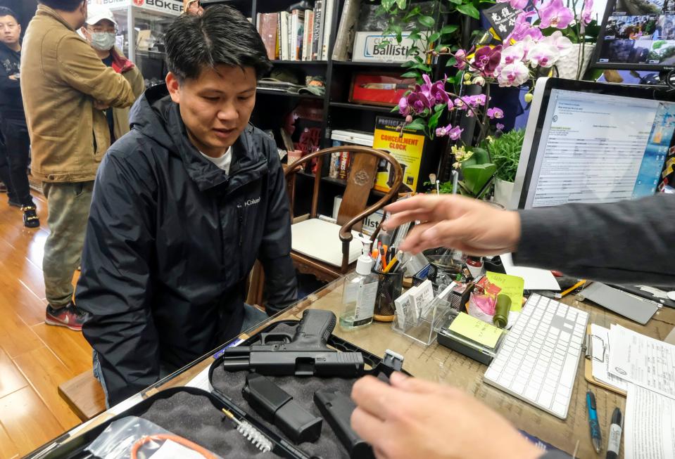 Brian Xia, 44, picks up his gun at a gun store in Arcadia, Calif., on March 15, 2020.