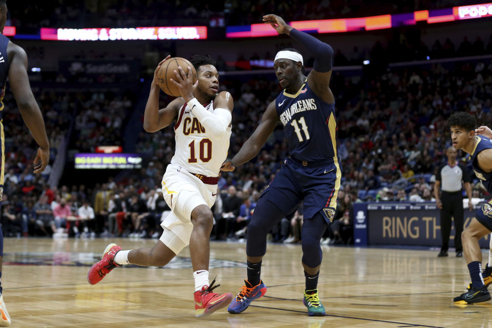 Cleveland Cavaliers guard Darius Garland (10) drives to the basket as New Orleans Pelicans guard Jrue Holiday (11) defends during the first half of an NBA basketball game in New Orleans, Friday, Feb. 28, 2020. (AP Photo/Rusty Costanza)