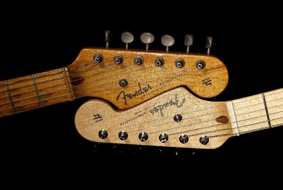 An original 1954 Fender Stratocaster head stock, left, is shown next to a 2014 model, Friday, Jan. 10, 2014 at a studio in Scottsdale, Ariz. April 2014 marks the 60th anniversary of the very first Stratocaster ever sold. (AP Photo/Matt York)