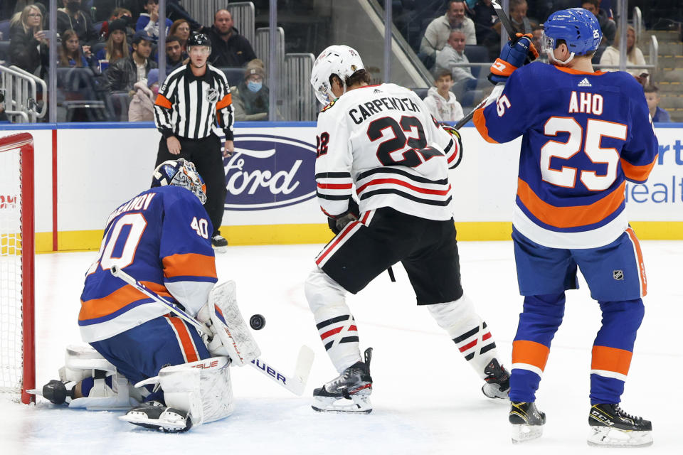 New York Islanders goaltender Semyon Varlamov (40) blocks a shot by Chicago Blackhawks center Ryan Carpenter (22) during the first period of an NHL hockey game, Sunday, Dec. 5, 2021, in Elmont, N.Y. (AP Photo/Corey Sipkin).