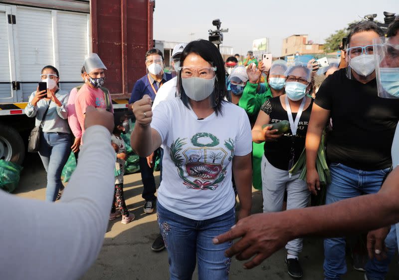 FILE PHOTO: Peru's presidential candidate Keiko Fujimori, who will face Pedro Castillo in a run-off election in June, greets supporters at a produce market, in Lima