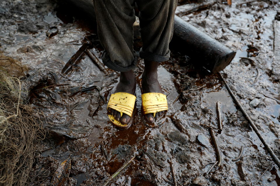 Benson Daniel, Community Development Chairman of the Sandsand fishing settlement, stands on oil-soaked ground at Sandsand, in Nembe, in Bayelsa, Nigeria, November 25, 2021. Picture taken November 25, 2021. REUTERS/Temilade Adelaja TPX IMAGES OF THE DAY