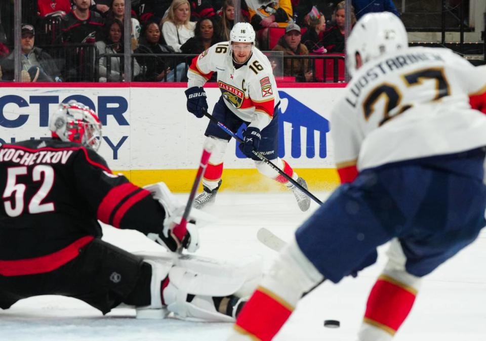 Feb 22, 2024; Raleigh, North Carolina, USA; Florida Panthers center Aleksander Barkov (16) makes a pass attempt past Carolina Hurricanes goaltender Pyotr Kochetkov (52) during the second period at PNC Arena. Mandatory Credit: James Guillory-USA TODAY Sports