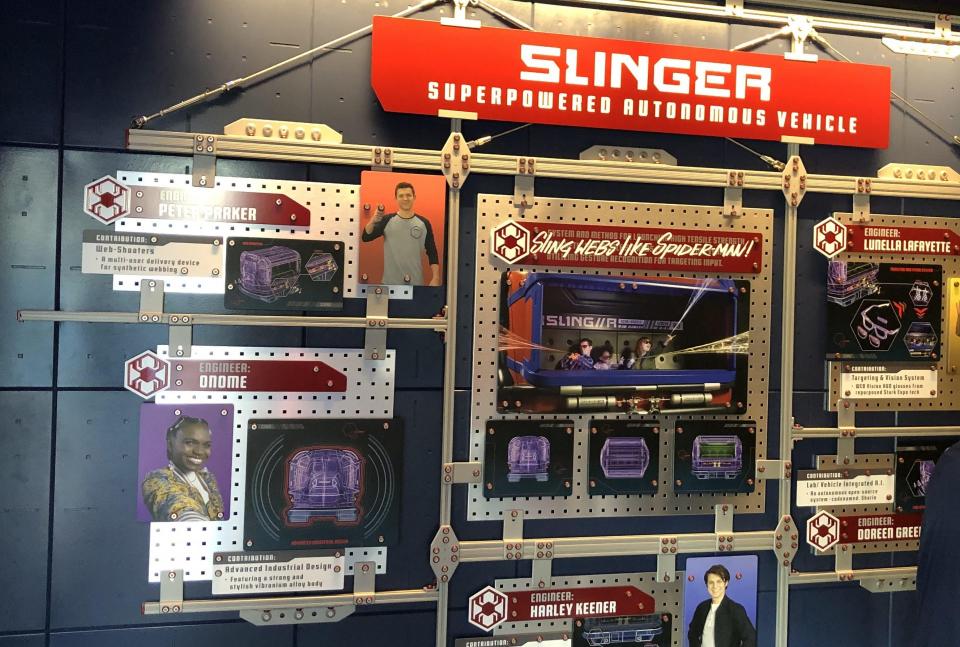 The wall upon entering the line queue at WEB Slingers: A Spider-Man Adventure, showing the young engineers of Stark industries.