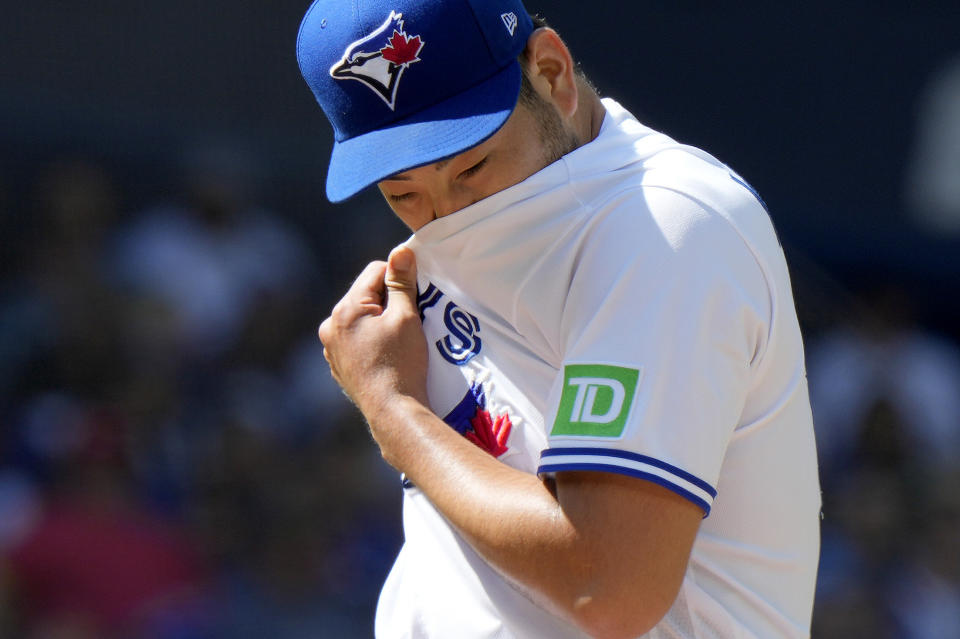 Toronto Blue Jays starting pitcher Yusei Kikuchi (16) reacts after giving up two runs during the fourth inning of a baseball game against the Cleveland Guardians in Toronto, Sunday, Aug. 27, 2023. (Frank Gunn/The Canadian Press via AP)