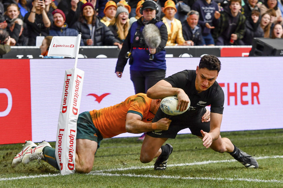 New Zealand's Shaun Stevenson scores a try in the tackle of Australia's Andrew Kellaway during the Bledisloe Cup rugby test match between the All Blacks and Australia in Dunedin, New Zealand, Saturday, Aug. 5, 2023. (John Davidson/Photosport via AP)