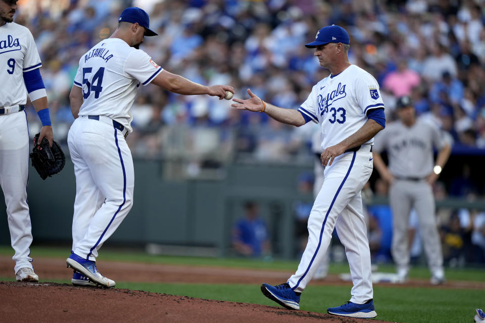 Kansas City Royals manager Matt Quatraro (33) takes the ball from starting pitcher Dan Altavilla (54) after making a pitching change during the first inning of a baseball game against the New York Yankees Wednesday, June 12, 2024, in Kansas City, Mo. (AP Photo/Charlie Riedel)