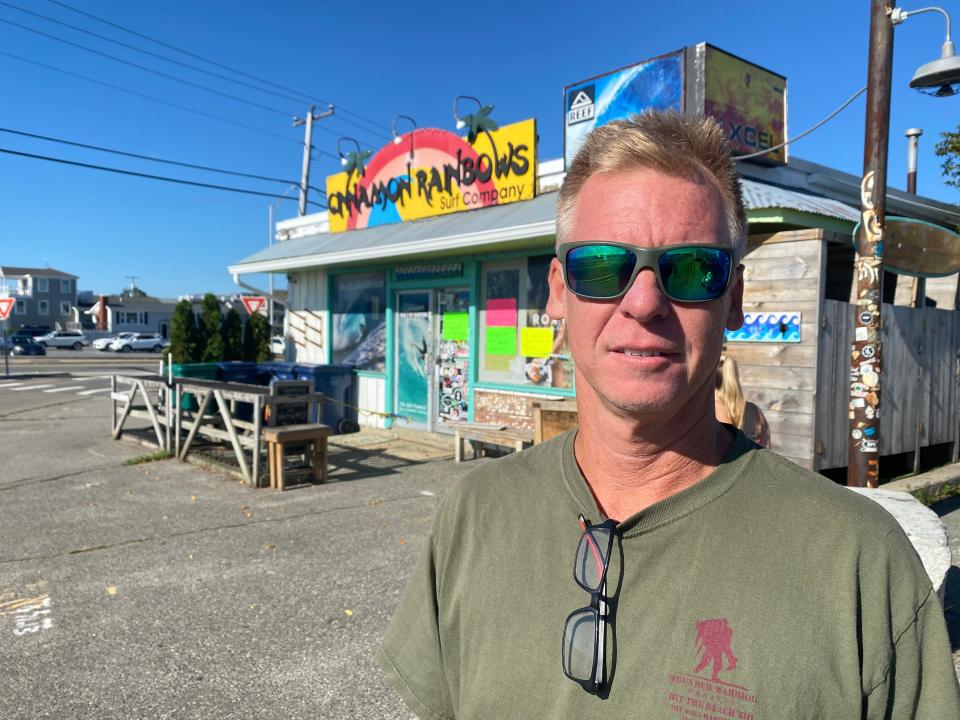 Cinnamon Rainbows Surf Co. owner Dave Cropper outside his shop where a fire struck Aug. 19. His staff has continued to sell inventory on the sidewalk since their shop was damaged by smoke.