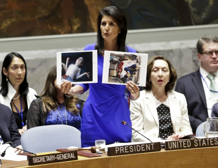 U.N. Ambassador Nikki Haley shows pictures of Syrian victims of chemical attacks as she addresses a meeting of the U.N. Security Council on Syria, April 5. (Photo: AP)