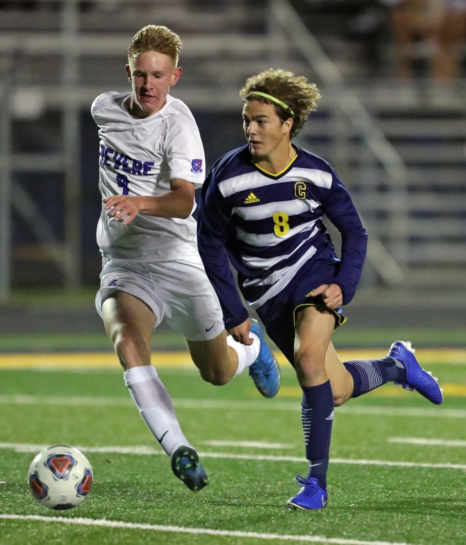 Copley's Matthew Luecke, right, takes the ball downfield past Revere's Jaden Yankovitz during the second half of a soccer game, Tuesday, Sept. 28, 2021, in Copley, Ohio.