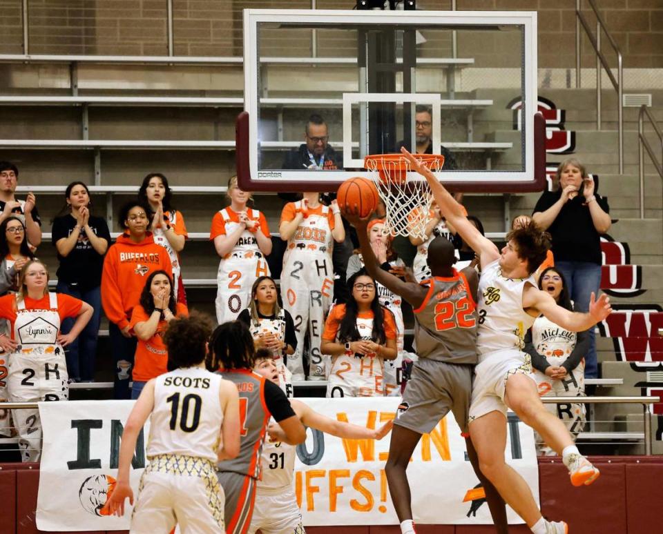 Haltom forward Kuol Atak (22) gets a bucket defended by Highland Park forward Jordan Stribling (3) in the third period of a UIL Conference 6A Division 1 boys bi-district basketball playoff game at Lewisville High School in Lewisville, Texas, Tuesday, Feb. 20, 2024.