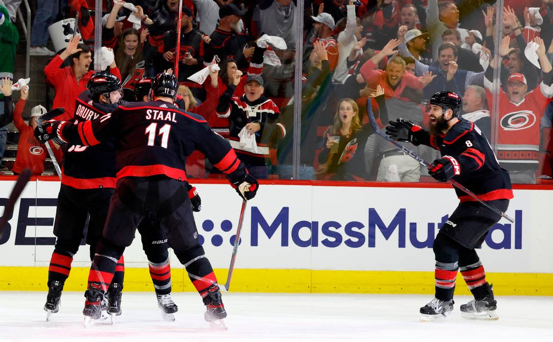 Carolina’s Jack Drury (18), Jordan Staal (11) and Brent Burns (8) celebrate with Jordan Martinook (48) after Martinook scored to put the Canes up 4-3 during the third period of the Hurricanes’ 5-3 victory over the Islanders in the first round of the Stanley Cup playoffs at PNC Arena in Raleigh, N.C., Monday, April 22, 2024.