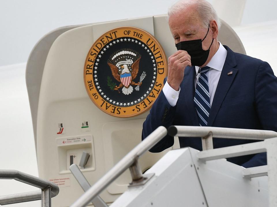 US President Joe Biden touches his face mask as he steps off Air Force One upon arrival at Hagerstown Regional Airport in Hagerstown, Maryland on April 14, 2022.