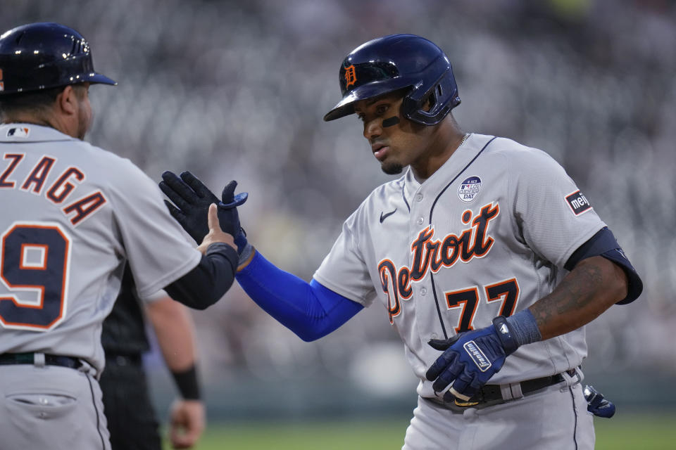 Detroit Tigers' Andy Ibanez, right, slaps hands with first base coach Alfredo Amezaga after hitting a single against the Chicago White Sox during the fifth inning of a baseball game Friday, June 2, 2023, in Chicago. (AP Photo/Erin Hooley)