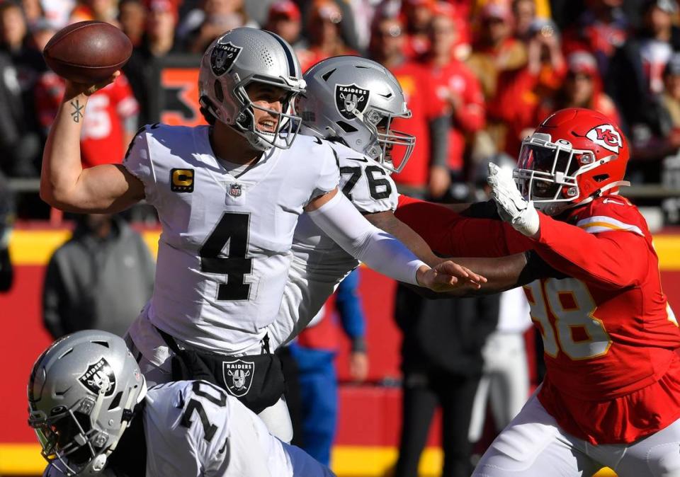 Las Vegas quarterback Derek Carr feels the pressure from the Chiefs pass rush of Tershawn Wharton during the first half of Sunday’s game at Arrowhead Stadium.