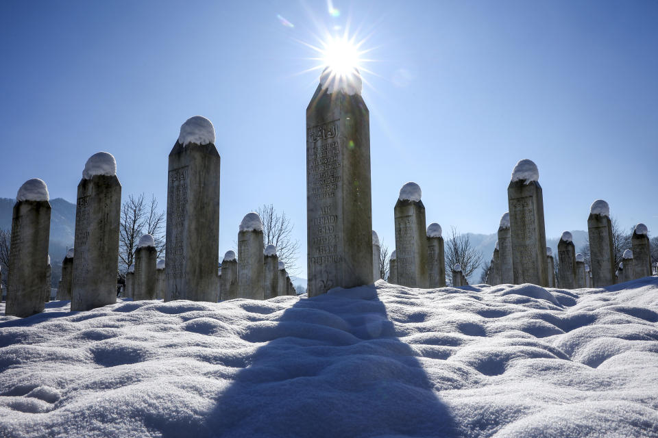 Snow caps the monuments at the Srebrenica Memorial Center in Potocari, Bosnia, Monday, Jan. 22, 2024. (AP Photo/Armin Durgut)