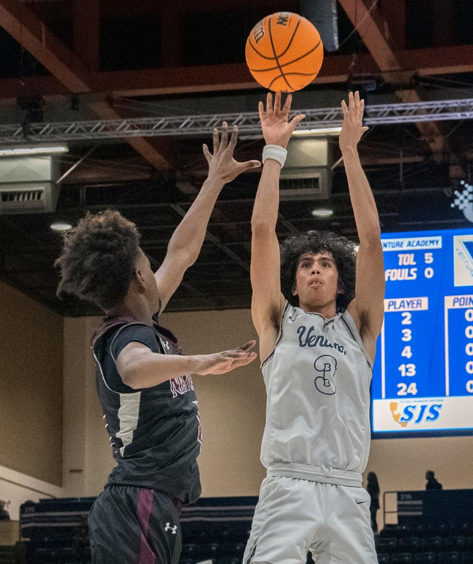 Venture Academy's Marcos Rosales, right, shoots over Natomas' Aeron Wallace during the Sac-Joaquin Section Div. 4 boys basketball championship game at U.C. Davis' University Credit Union Center in Davis on Feb. 23, 2024. Venture Academy won 78-74.