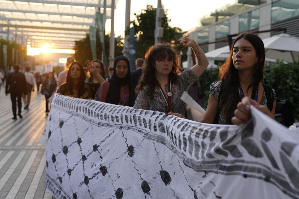 Demonstrators participate in a protest against the Israel-Hamas war during the COP28 U.N. Climate Summit, Wednesday, Dec. 6, 2023, in Dubai, United Arab Emirates. (AP Photo/Rafiq Maqbool)