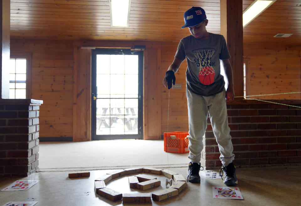Evan Williams, 11, plays with his yo-yo at the YMCA Camp Kon-O-Kwee Spencer on Thursday, June 29, 2023, in Zelienople, Pa. Due to the poor air quality caused by the Canadian wildfires the Western Pennsylvania summer camp closed its outdoor pool, transitioned to indoor activities and sent home a few campers with health problems. (AP Photo/Jessie Wardarski)