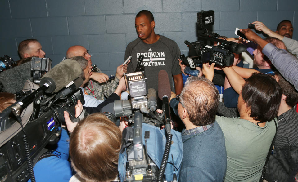 Brooklyn Nets center Jason Collins talks to reporters before the Nets faced the Denver Nuggets in an NBA basketball game in Denver on Thursday, Feb. 27, 2014. (AP Photo/David Zalubowski)