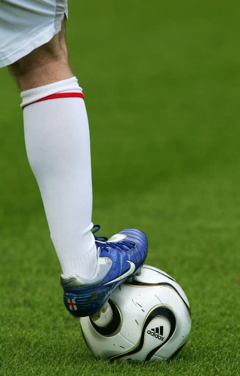 English forward Wayne Rooney places his injured right foot on a ball as he trains alone on June 6, 2006