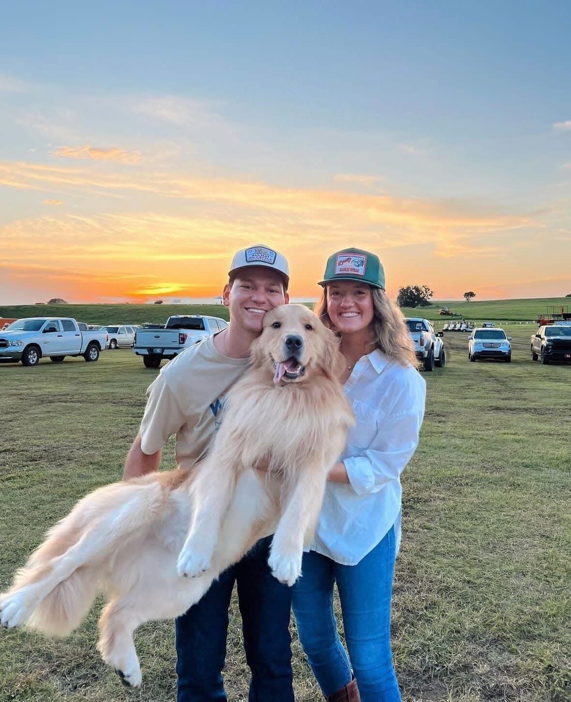 a man and woman holding a dog