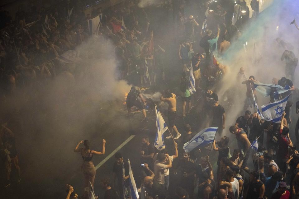 Riot police try to clear demonstrators with a water canon during a protest against plans by Netanyahu's government to overhaul the judicial system in Tel Aviv, Monday, July 24, 2023. (AP Photo/Oded Balilty)