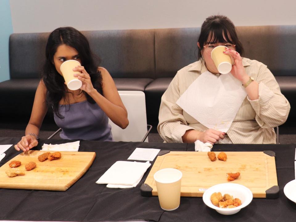 Two of Insider's reporters drinking milk.