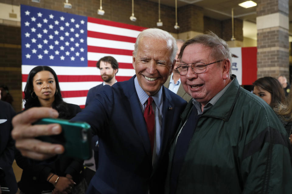 Democratic presidential candidate former Vice President Joe Biden poses for a photo with Henry Marquard, of Muscatine, Iowa, during a community event, Wednesday, Oct. 16, 2019, in Davenport, Iowa. (AP Photo/Charlie Neibergall)