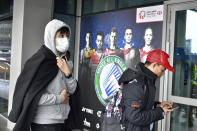 Spectators enter the Arena Birmingham to watch the finals at the All England Open Badminton tournament in Birmingham, England, Sunday, March 15, 2020. For most people, the new coronavirus causes only mild or moderate symptoms, such as fever and cough. For some, especially older adults and people with existing health problems, it can cause more severe illness, including pneumonia. (AP Photo/Rui Vieira)