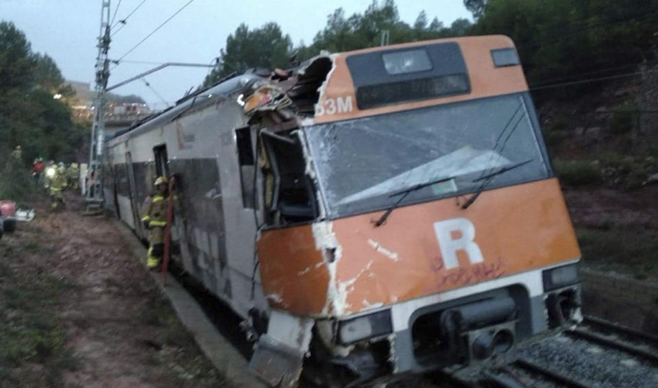 Emergency workers at the scene of an accident after a passenger train collided with a landslide, near Vacarisses, some 45 kilometers northwest of Barcelona, Spain, Tuesday Nov. 20, 2018. One person died and dozens were injured Tuesday after a landslide derailed a commuter train traveling toward Barcelona, Spanish authorities said. (Anti-radar Catalunya via AP)