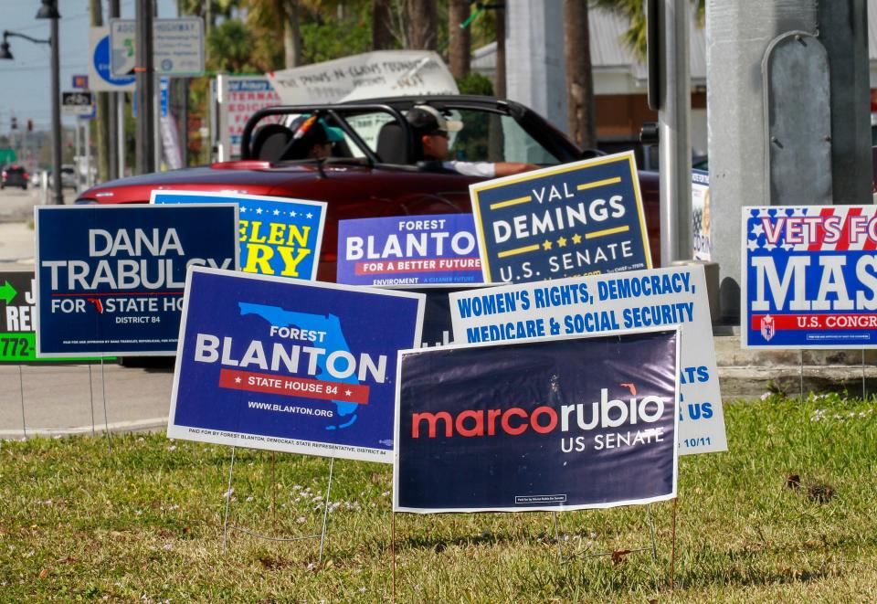 Campaign signs along U.S. 1 at the intersection of Midway Road are seen on Monday, November 7, 2022, as a reminder for election day voters to cast their ballots at their voting precincts.