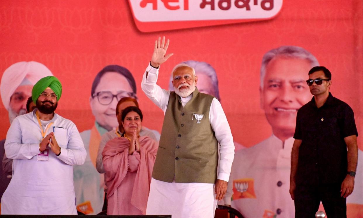 <span>Narendra Modi (centre), India's Prime Minister and leader of the ruling Bharatiya Janata Party (BJP) gestures to his supporters during an election campaign rally in Gurdaspur on May 24, 2024, amid the country's ongoing general election.</span><span>Photograph: Narinder Nanu/AFP/Getty Images</span>