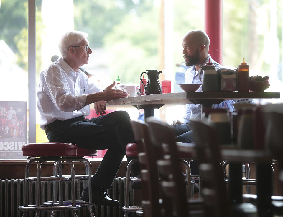 After winning their races in Wisconsin's primary elections Democratic candidate for governor Tony Evers, left, and Democratic candidate for lieutenant governor Mandela Barnes talk over breakfast at Mickie's Dairy Bar in Madison, Wis., Wednesday, Aug. 15, 2018. (John Hart/Wisconsin State Journal via AP)