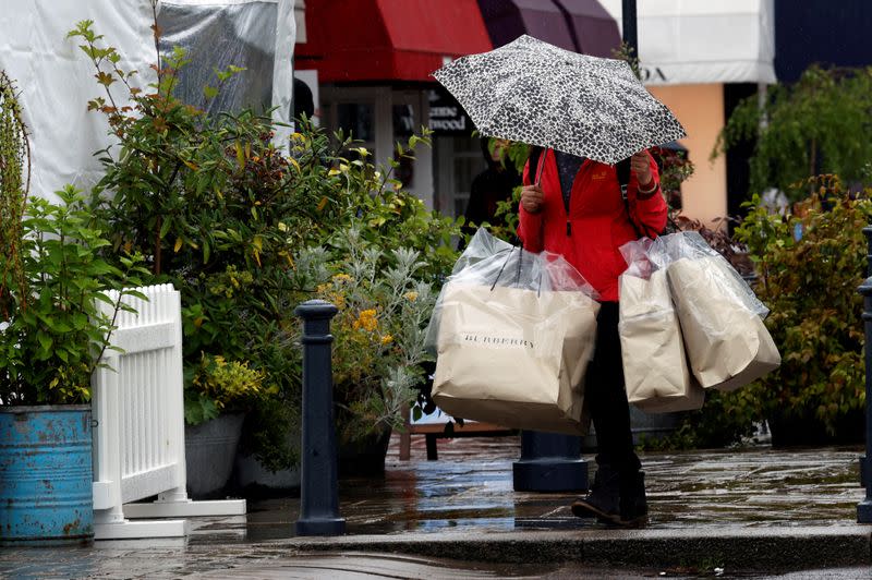 FILE PHOTO: Shopper carries bags at Bicester Village