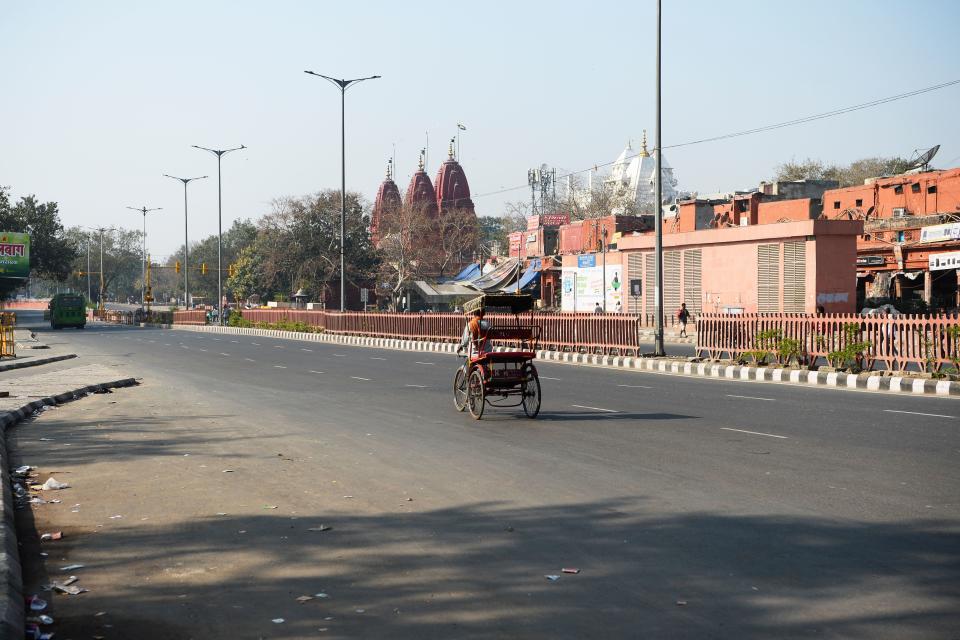 A cycle rickshaw puller rides through a deserted road during a one-day Janata (civil) curfew imposed amid concerns over the spread of the COVID-19 novel coronavirus, in the old quarters of New Delhi on March 22, 2020. (Photo by Sajjad HUSSAIN / AFP) (Photo by SAJJAD HUSSAIN/AFP via Getty Images)