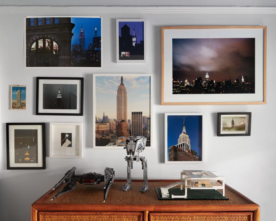 Photos of the Empire State Building by Schmidt and others in Jules’s room.