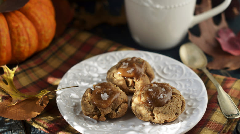 thumbprint cookies on plate with mug and pumpkin