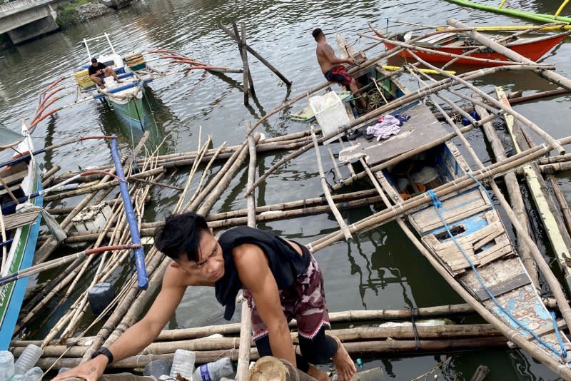 Fishermen secure boats in anticipation of an approaching typhoon in Las Pinas city, Metro Manila, Philippines, on July 25. Photo by Francis R. Malasig/EPA-EFE