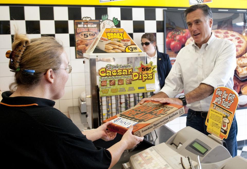 US Republican presidential candidate and former Massachusetts Governor Mitt Romney talks with Marci Miller (L) as he visits a Little Caesars pizza restaurant during a stop between campaign events in Cambridge, Ohio, August 14, 2012. (SAUL LOEB/AFP/GettyImages)