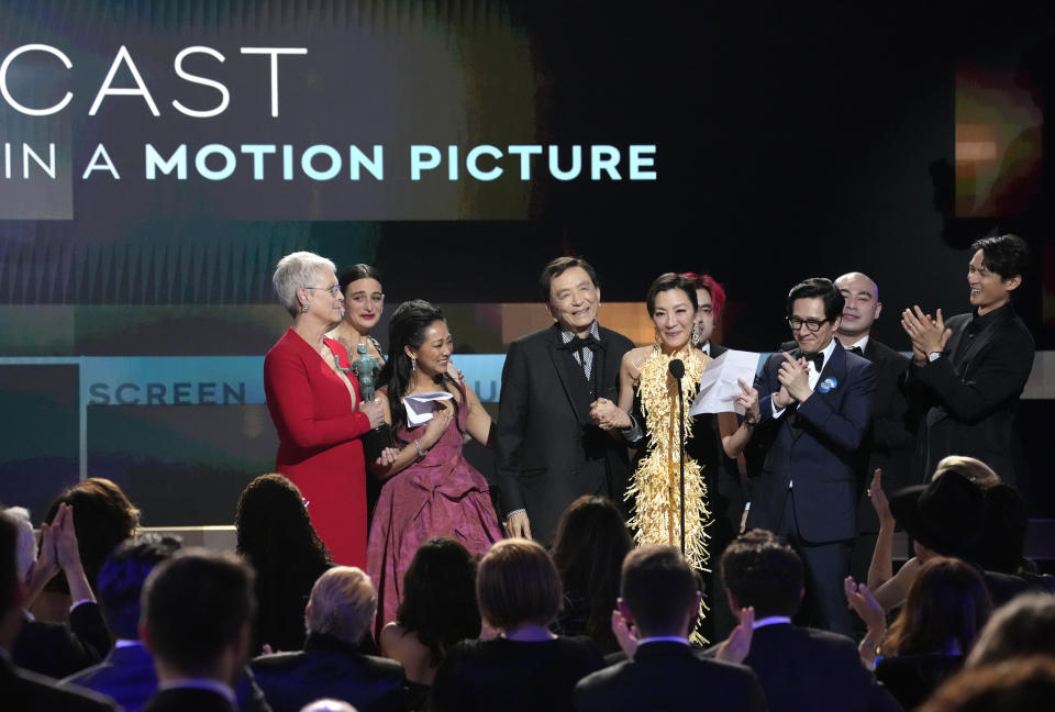 Michelle Yeoh, center, and members of the cast of "Everything Everywhere All at Once," accept the award for outstanding performance by a cast in a motion picture at the 29th annual Screen Actors Guild Awards on Sunday, Feb. 26, 2023, at the Fairmont Century Plaza in Los Angeles. (AP Photo/Chris Pizzello)