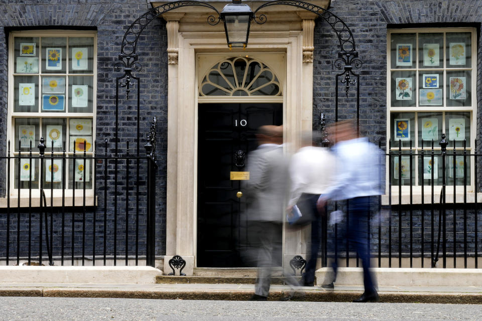 People arrive at 10 Downing Street in London, Monday, May 23, 2022. The general public is awaiting the release of Sue Gray's report into COVID lockdown breaches across Whitehall, the so called "Partygate". (AP Photo/Frank Augstein)