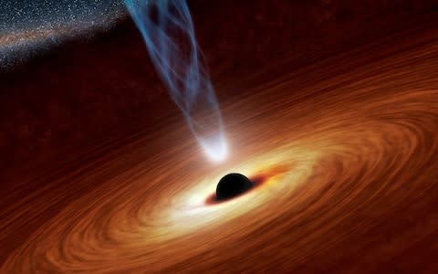 An artists impression showing how a supermassive black hole sucks in matter and light  - Credit: Nasa&nbsp;