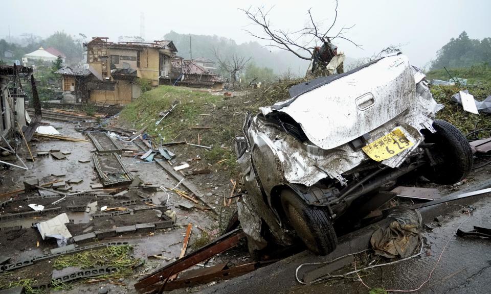 A damaged car lies on the ground following a strong wind in Ichihara, Chiba, near Tokyo Saturday, Oct. 12, 2019. Under gloomy skies, a tornado ripped through Chiba on Saturday.(Kyodo News via AP)