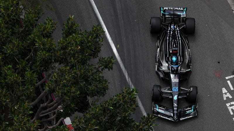 A photo of George Russell racing his black Mercedes F1 car in Monaco. 